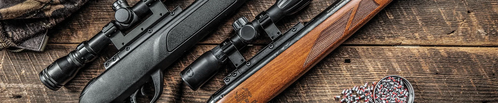 Gamo Official Air Rifle Range Gamo air rifles, scopes and pellets arranged on a wooden surface