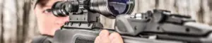 Airgun shooter aiming through a scope in an official Gamo heritage image